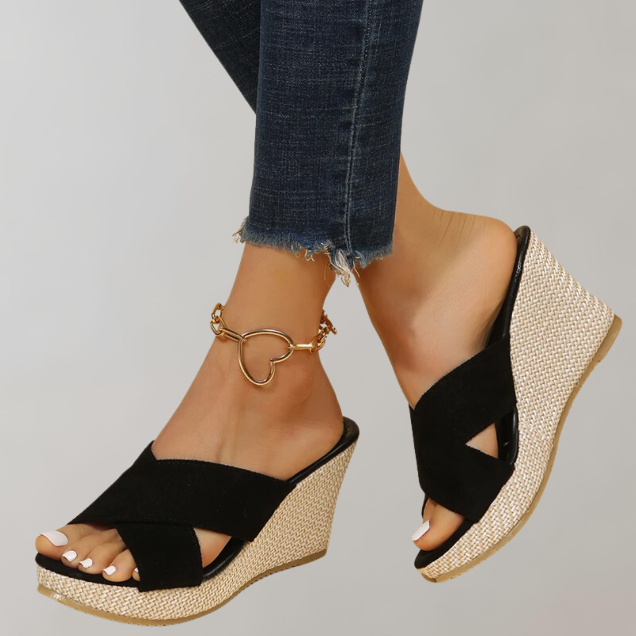 Black wedge sandals with open toes and pale woven-look heels.