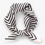 Black-and-white geometric striped scarf tied at the front.