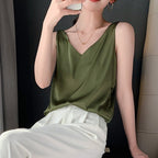 Army green Trigala tank top worn with light trousers.