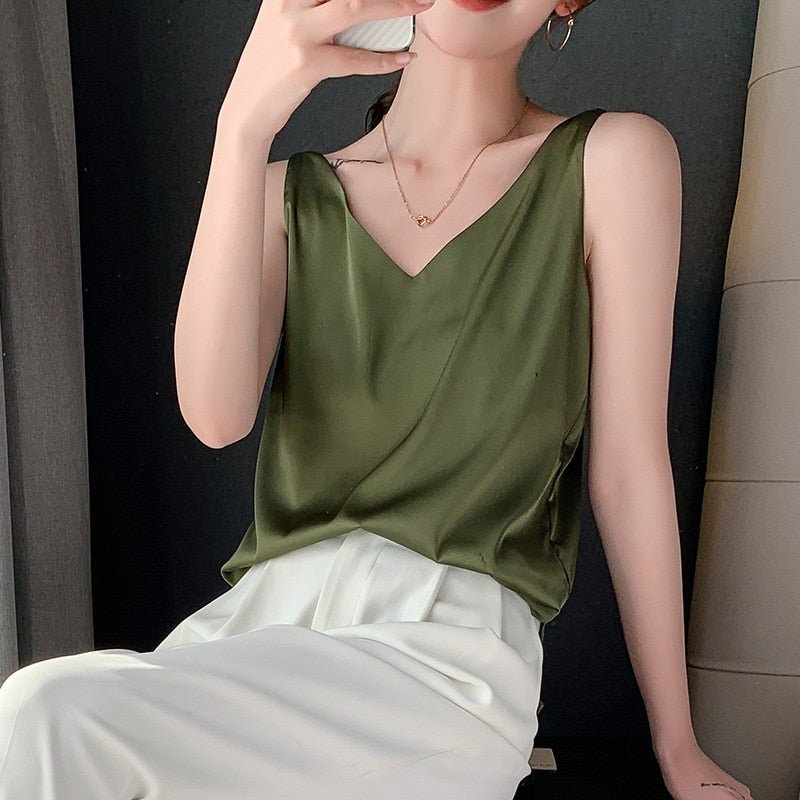 Army green Trigala tank top worn with light trousers.