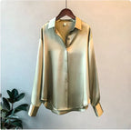 Olive green shirt with a relaxed shape and button-through front on a hanger.