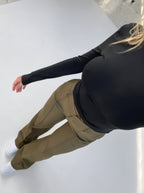 Overhead view of olive-green trousers with belt loops and front seams.