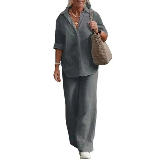 Grey two-piece set with a collared shirt and full-length trousers.