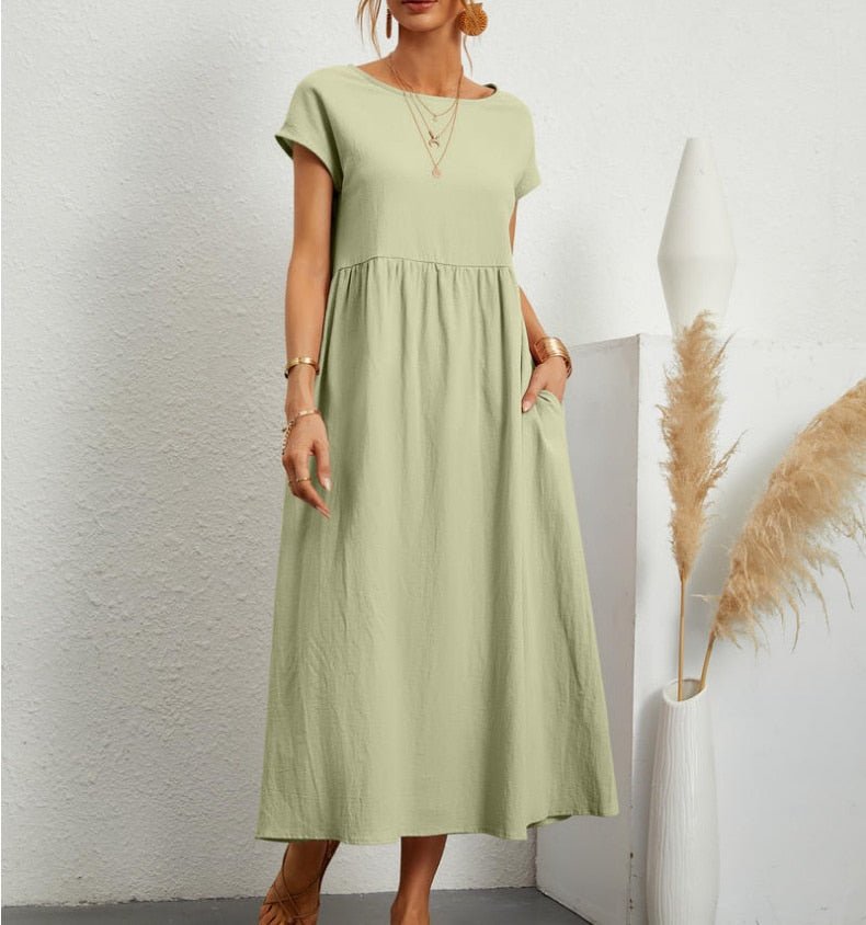 Light green Ginovu dress with a gathered waist and long skirt.