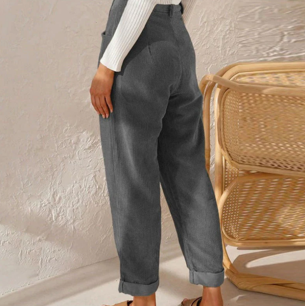 Rear view of grey ribbed trousers.