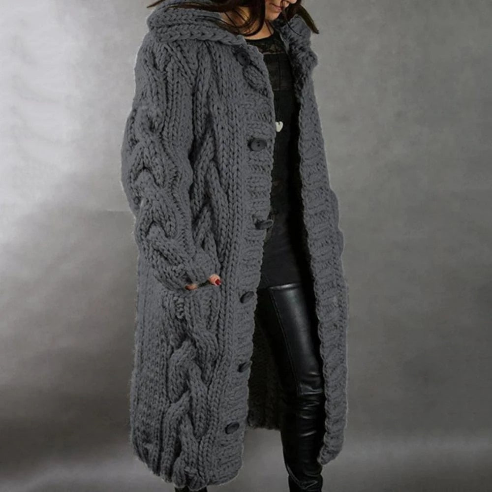 Dark-grey knee-length knit coat with cable patterns.
