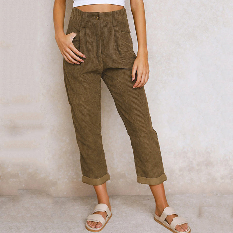 Dark brown trousers with front pockets and rolled hems.