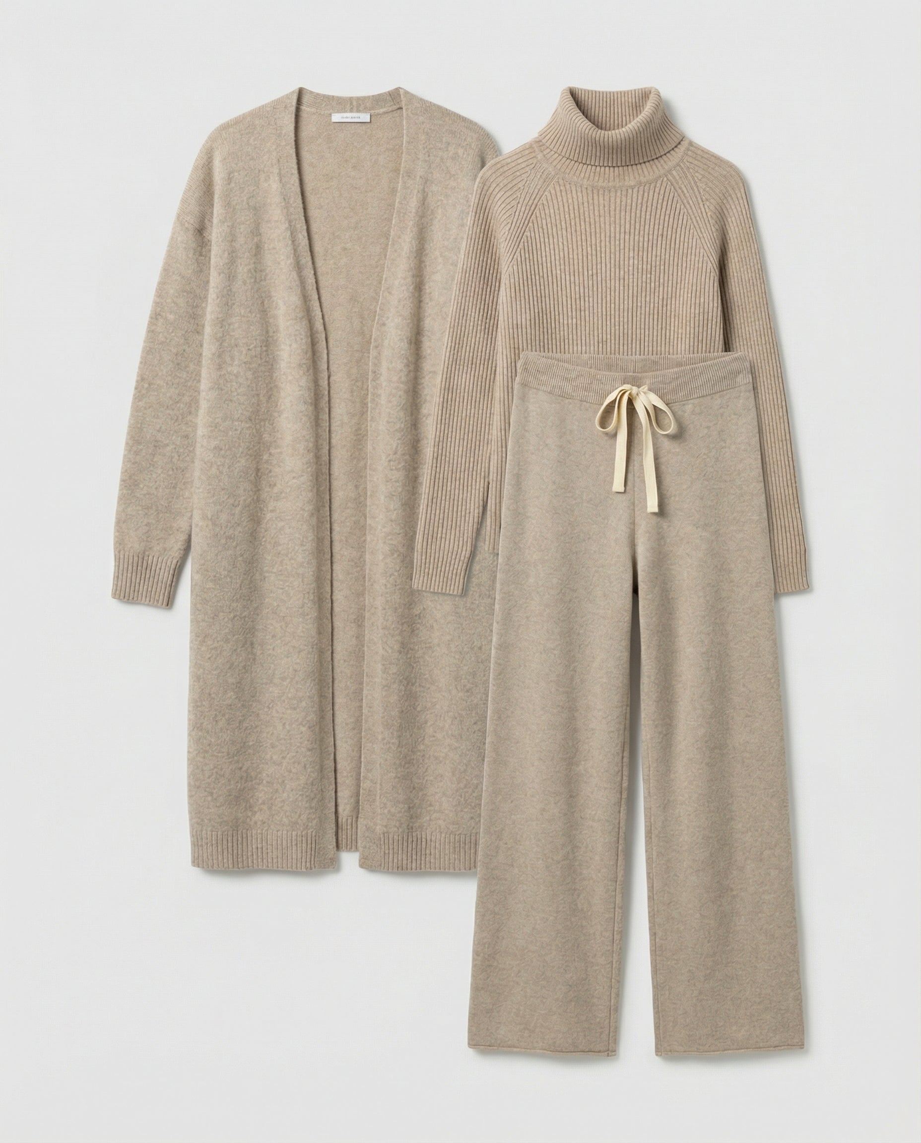 Three beige knit pieces laid flat, with a roll-neck top and tied trouser waistband.