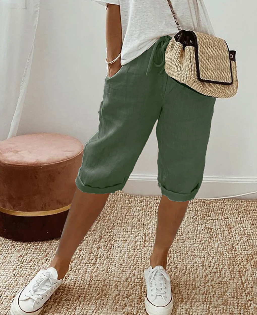 Green knee-length shorts with a high waist and side pockets.