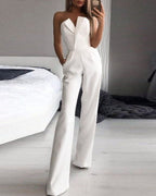 White strapless jumpsuit with front waist pleats and side pockets.