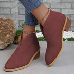 Wine red ankle boots with a notched front, worn with cropped jeans.