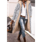 Grey long quilted jacket worn over jeans.