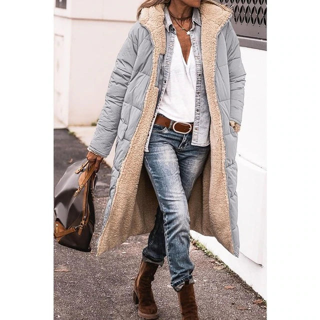 Grey long quilted jacket worn over jeans.