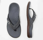 Black flip-flops with dotted footbeds and silver-coloured buckles.
