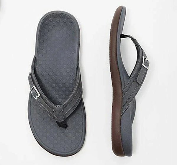 Black flip-flops with dotted footbeds and silver-coloured buckles.