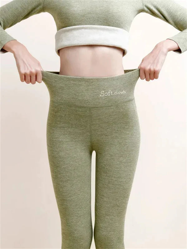 Green leggings with close-fitting legs and a stretched waistband.