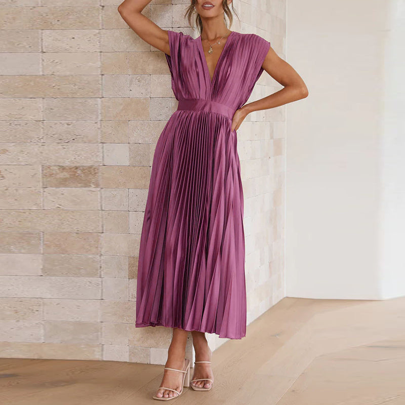 Purple pleated midi dress shown with one arm raised.
