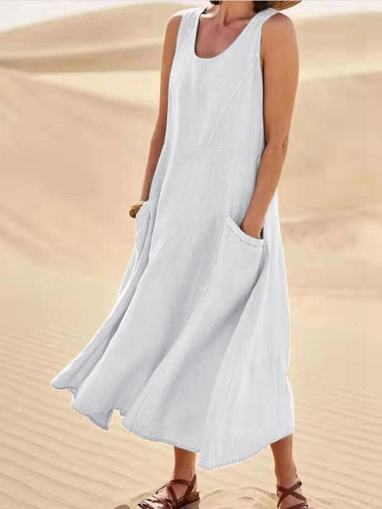 White sleeveless dress with a loose long skirt and patch pockets.