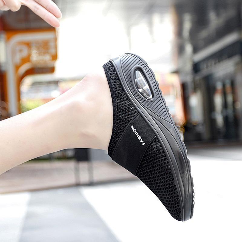 Side view of a black mesh mule showing the oval heel insert.