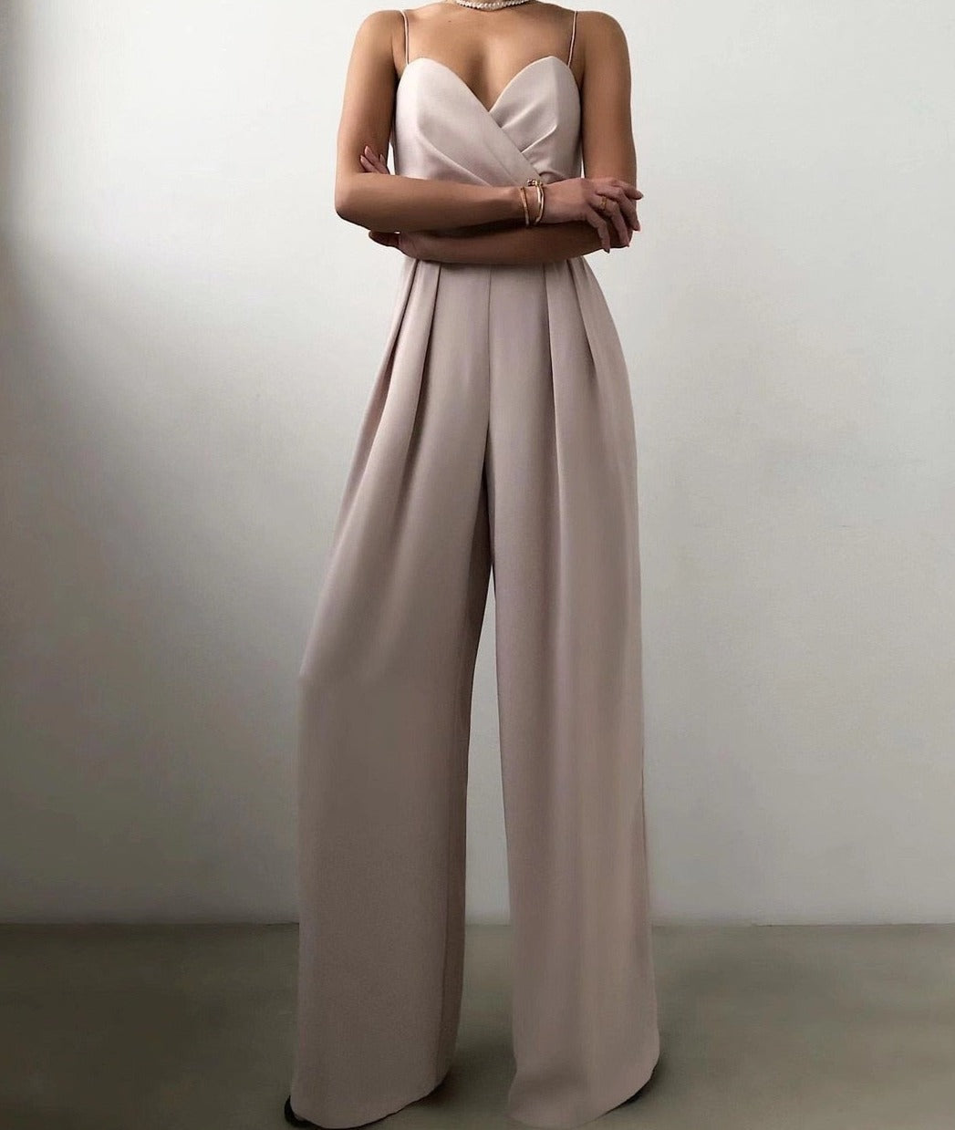Pale apricot jumpsuit with long wide legs.