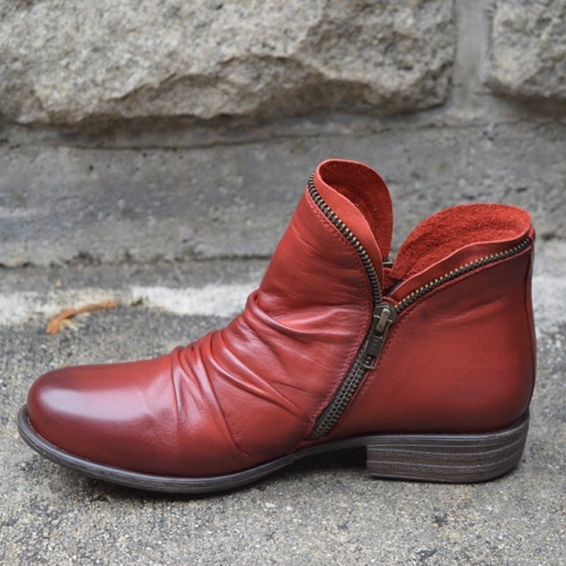 Red faux-leather ankle boot with a dark low heel.