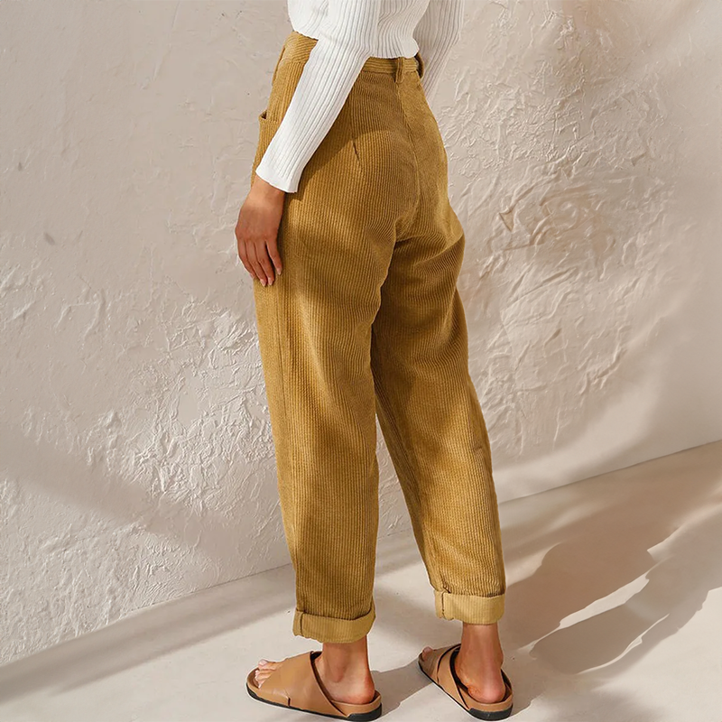 Mustard-yellow corduroy trousers shown from behind with rolled hems.