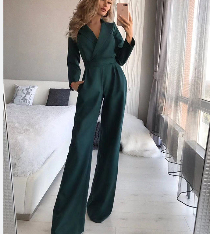 Dark green long-sleeve jumpsuit shown with one hand in a pocket.