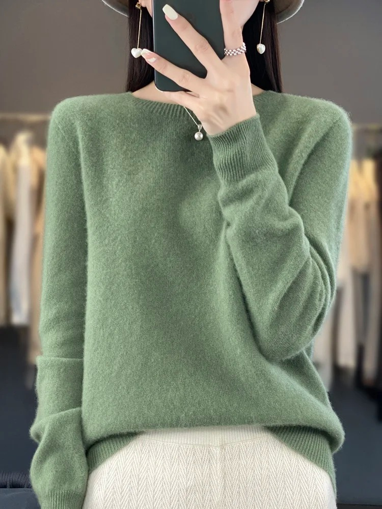 Muted green jumper with long sleeves and ribbed cuffs.