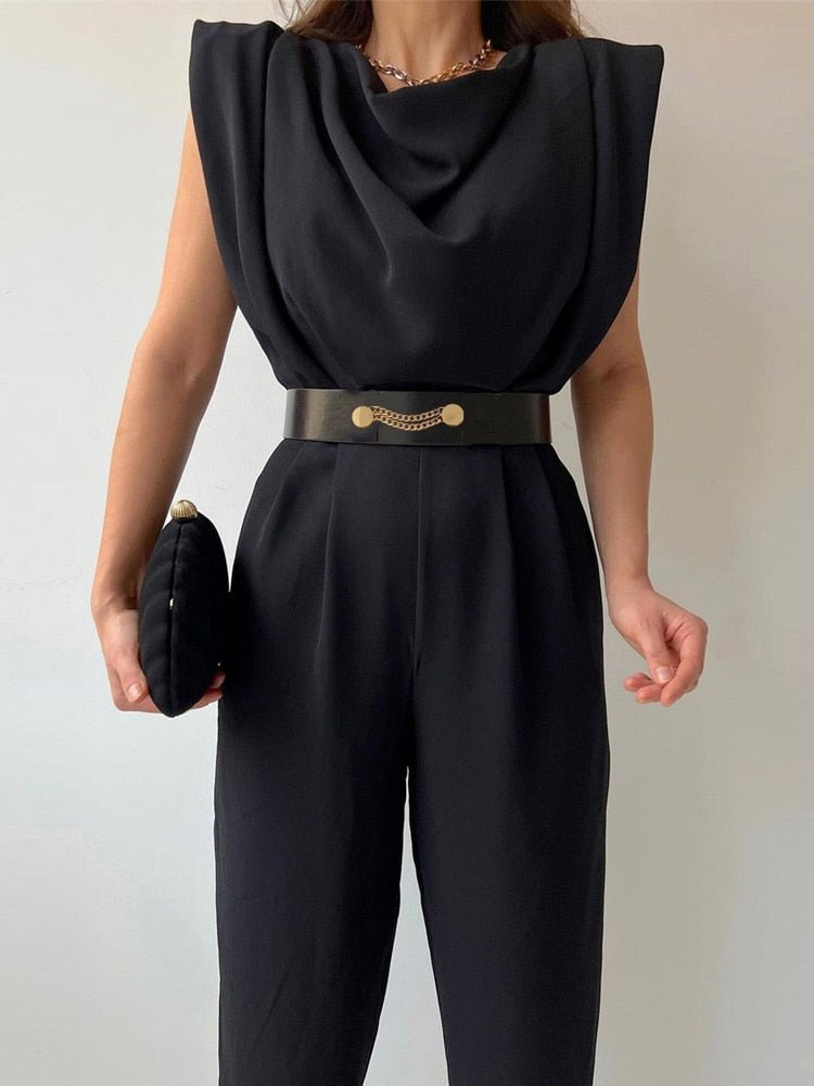 Black round-neck jumpsuit with a draped front and decorative belt.