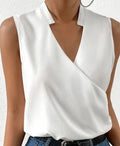 White sleeveless top with a crossover V-neck and short collar.