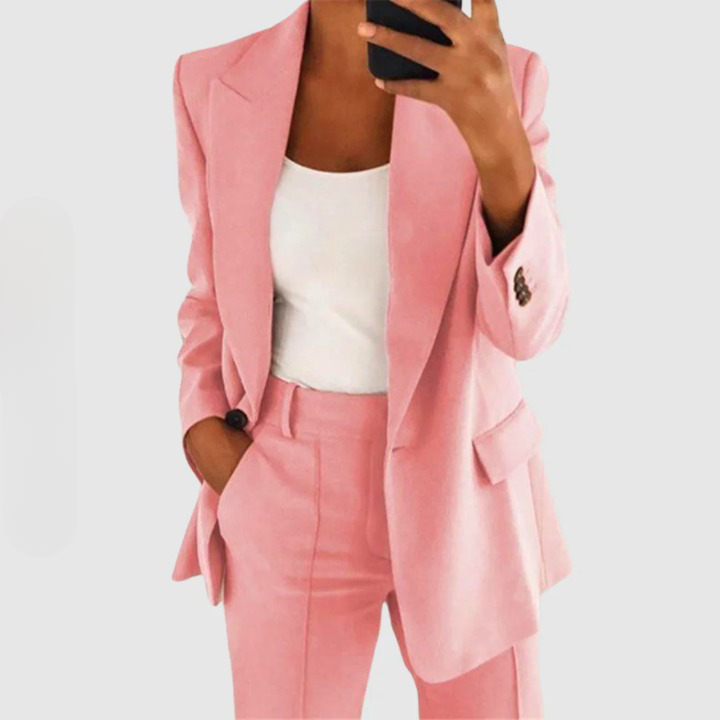 Close view of a pink blazer and matching trousers.