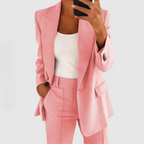 Close view of a pink blazer and matching trousers.
