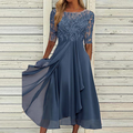 Dusty blue party dress with a lace bodice, elbow-length sleeves and a draped skirt.