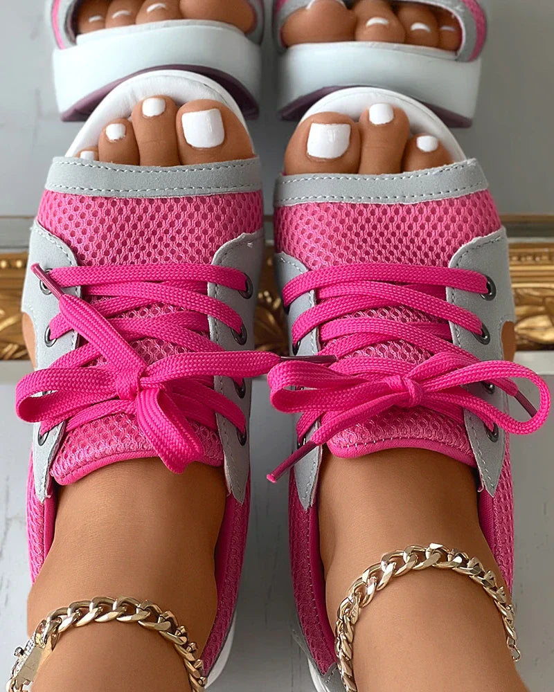 Pink lace-up sandals shown from above.
