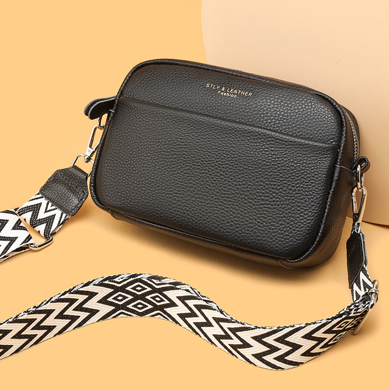 Black bag with a grained front pocket and printed lettering.
