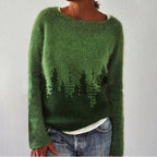 Green jumper with dark tree silhouettes across the lower body.