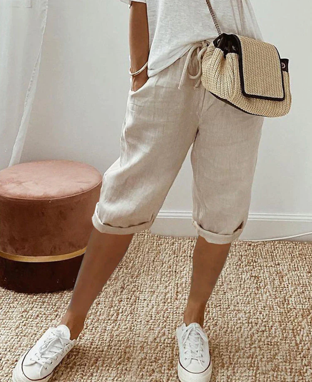 Beige knee-length shorts with a drawstring waist, side pockets and turned-up hems.