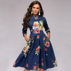 Navy dress with large multicoloured flowers shown from the front.
