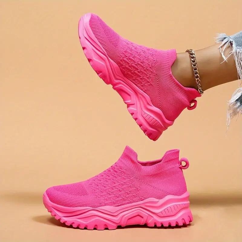 Bright pink trainers with matching chunky soles, shown from the side.