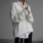 White fluffy cardigan worn over a collared white shirt.