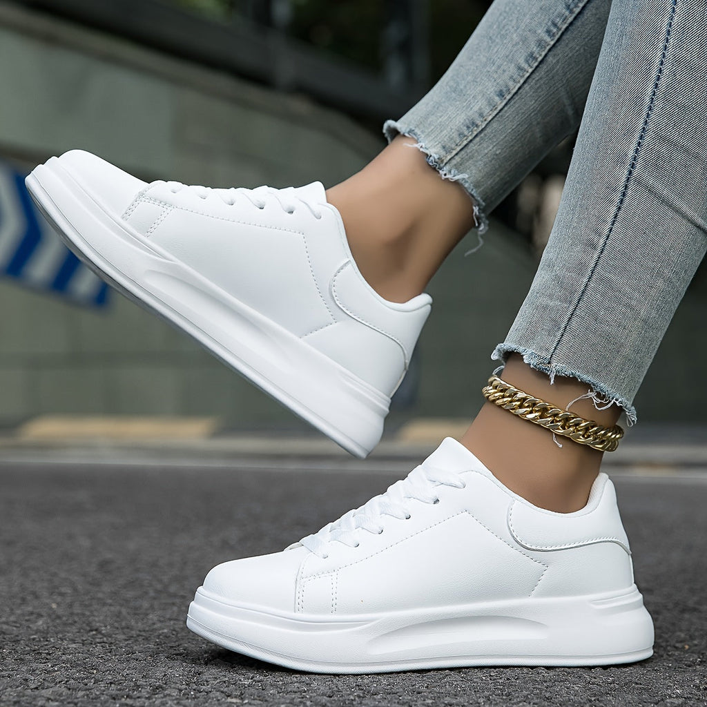All-white trainers with stitched side panels and lace-up fronts.