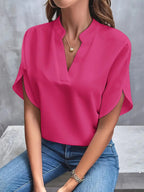 Pink short-sleeve blouse with a small stand collar.