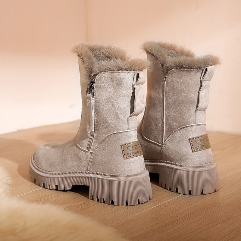 Rear view of apricot ankle boots with fluffy top edges and chunky soles.