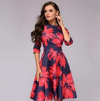 Dark dress with large red flowers and three-quarter sleeves.