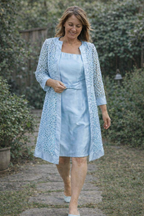Light blue dress worn beneath a matching lace-effect jacket.