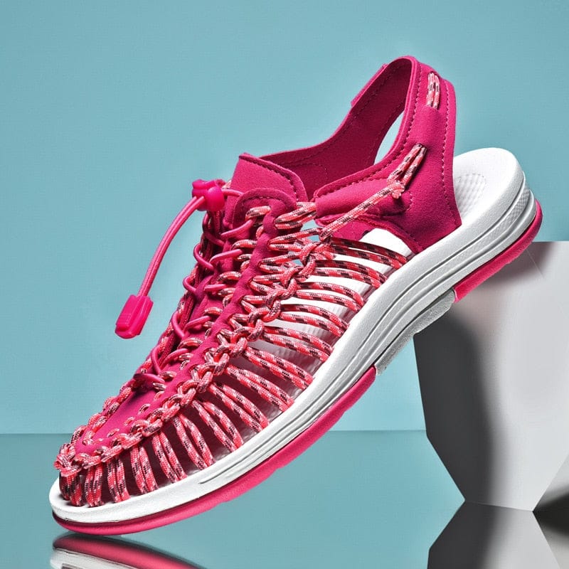Pink cord sandal with a toggle lace and open sides, shown from above.