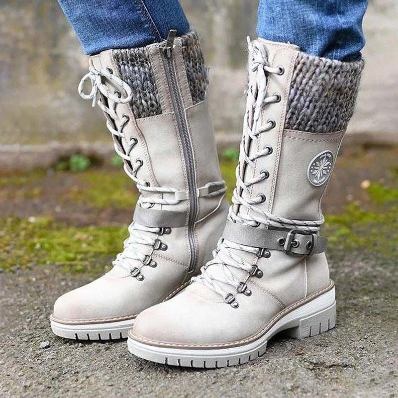 White Bootlix boots worn with jeans, showing side zips and knit cuffs.