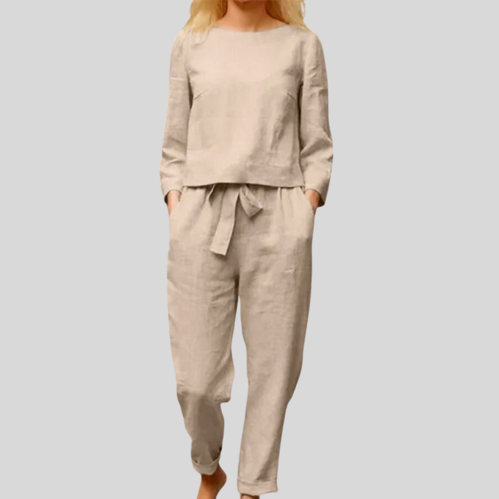 Beige long-sleeve top and matching trousers worn with a fabric waist tie.
