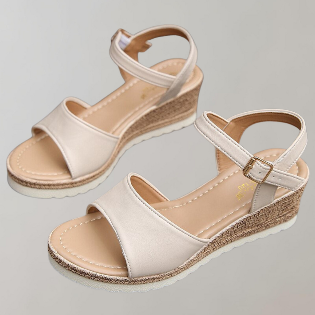 Beige wedge sandals showing the footbeds and open heels.