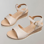 Beige wedge sandals showing the footbeds and open heels.